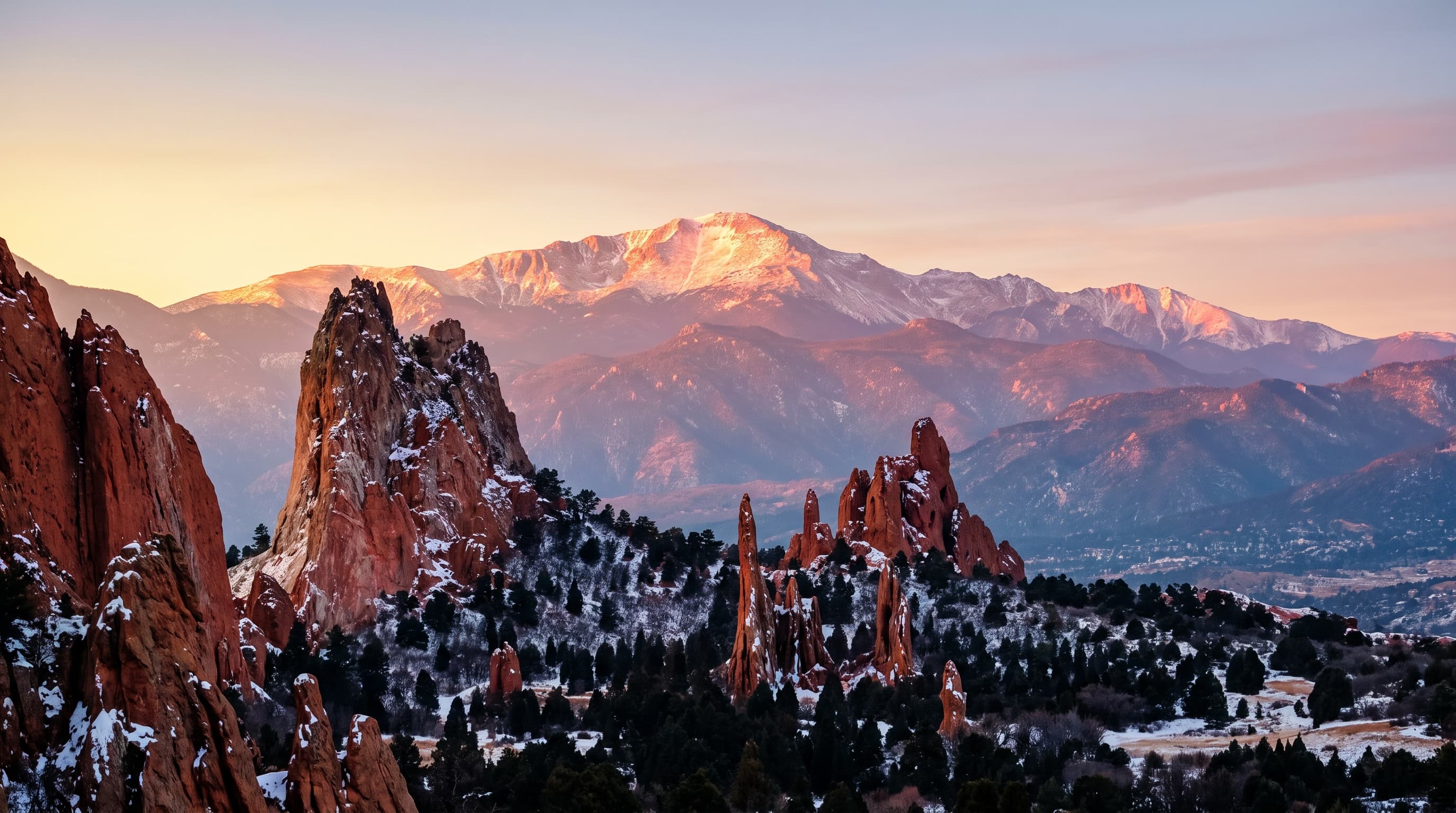 Garden of the Gods red rock formations at dawn with snow-dusted Pikes Peak beyond